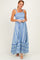 woman wearing a blue and white striped maxi dress with smocked bodice and ruffled straps