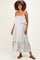 woman wearing a striped white maternity maxi dress with ruffled layers and spaghetti straps