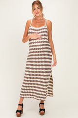 woman wearing a brown and cream patterned maternity maxi dress with a side slit and holding her baby bump
