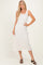 woman wearing a white floral lace midi dress with a square neckline and spaghetti straps