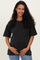 woman wearing a black oversized maternity t-shirt with a front pocket and holding her baby bump