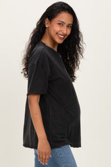 woman wearing a black oversized maternity t-shirt and showcasing her baby bump