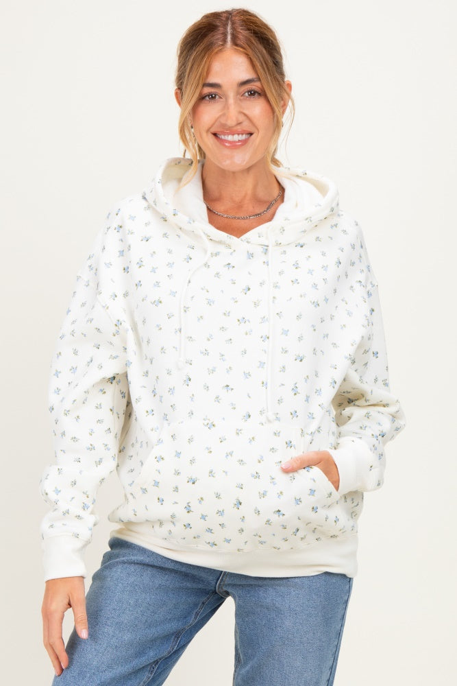 woman wearing a white floral maternity hoodie with a front pocket and relaxed fit