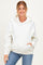 woman wearing a white floral maternity hoodie with a front pocket and relaxed fit