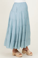 woman wearing a light blue tiered maternity skirt with a flowy design and espadrille wedges