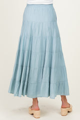 woman wearing a light blue maternity maxi skirt with tiered layers and an elastic waistband