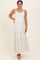 woman wearing a white tiered maternity maxi dress with adjustable straps and a visible baby bump