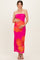 woman wearing a pink strapless maternity dress with large floral print and holding her baby bump