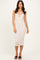 woman wearing a beige ribbed midi dress with a sweetheart neckline and front clasp detail