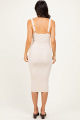 woman wearing a beige ribbed midi dress with adjustable straps, shown from the back