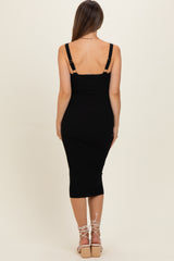 woman wearing a black ribbed maternity dress with adjustable shoulder straps, showing a fitted silhouette from the back