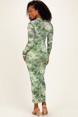 woman wearing a green floral long sleeve bodycon dress, showcasing a fitted silhouette and mid-calf length
