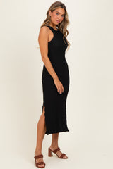 woman wearing a black sleeveless ribbed midi dress with side slits and styled with brown heeled sandals
