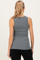woman wearing a gray sleeveless maternity top with ruching in the back