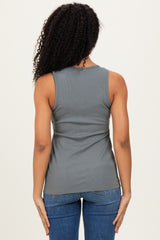 woman wearing a back view of a gray ribbed tank top paired with blue jeans.