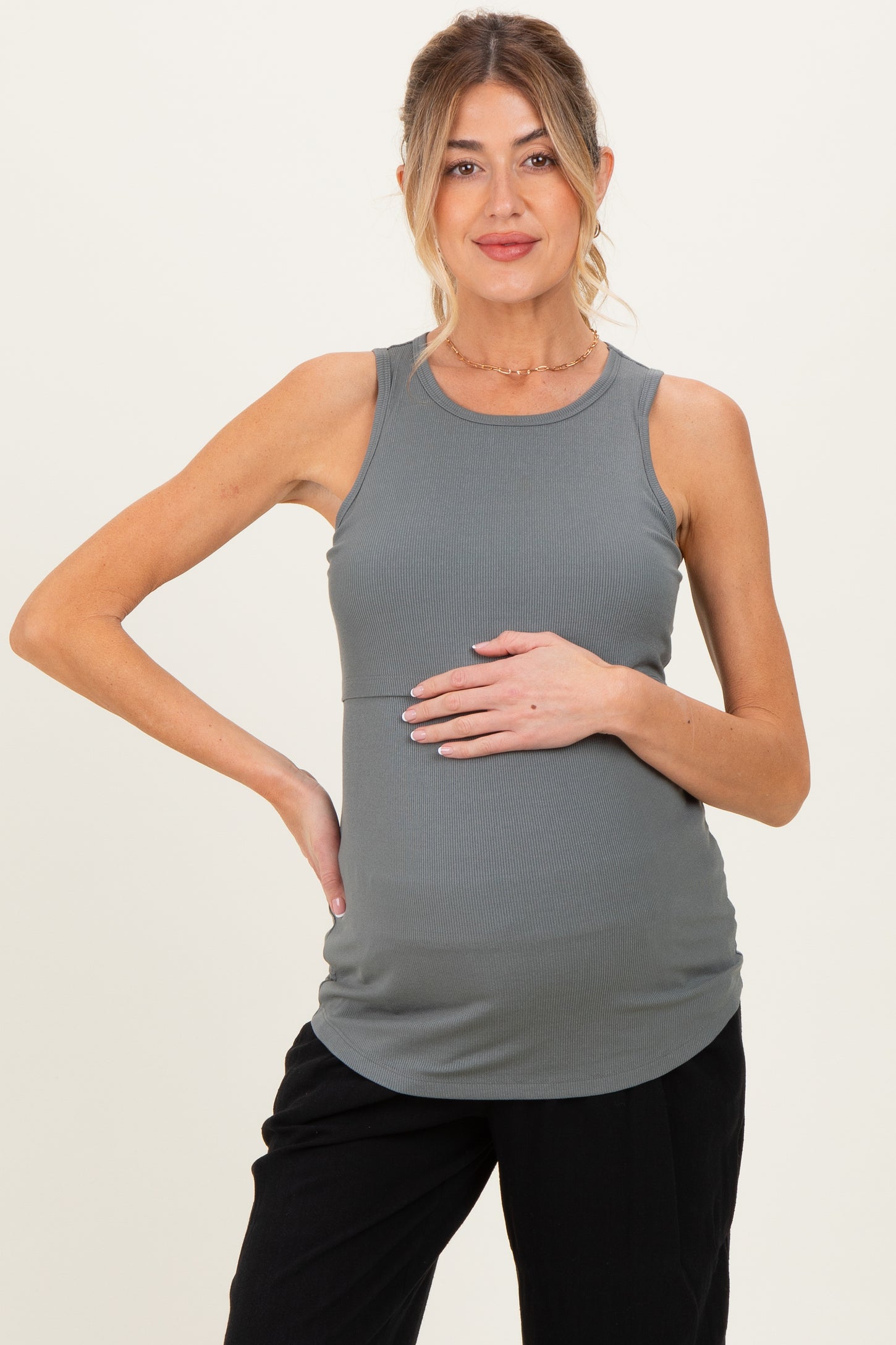 woman wearing a gray ribbed maternity tank top and holding her baby bump