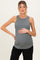 woman wearing a gray ribbed maternity tank top and holding her baby bump