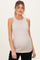 woman wearing a light taupe ribbed maternity tank top that highlights her baby bump