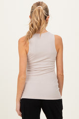 woman wearing a light beige ribbed maternity tank top, viewed from the back