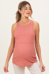 woman wearing a dusty rose maternity tank top with a fitted bodice and a gathered hem, showcasing her baby bump