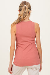 woman wearing a coral ribbed maternity tank top, view from the back