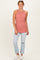 woman wearing a rust-colored ribbed sleeveless top with a layered effect and light blue distressed jeans