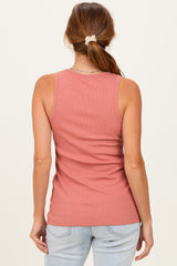 woman wearing a salmon pink ribbed tank top, shown from the back, paired with light blue jeans