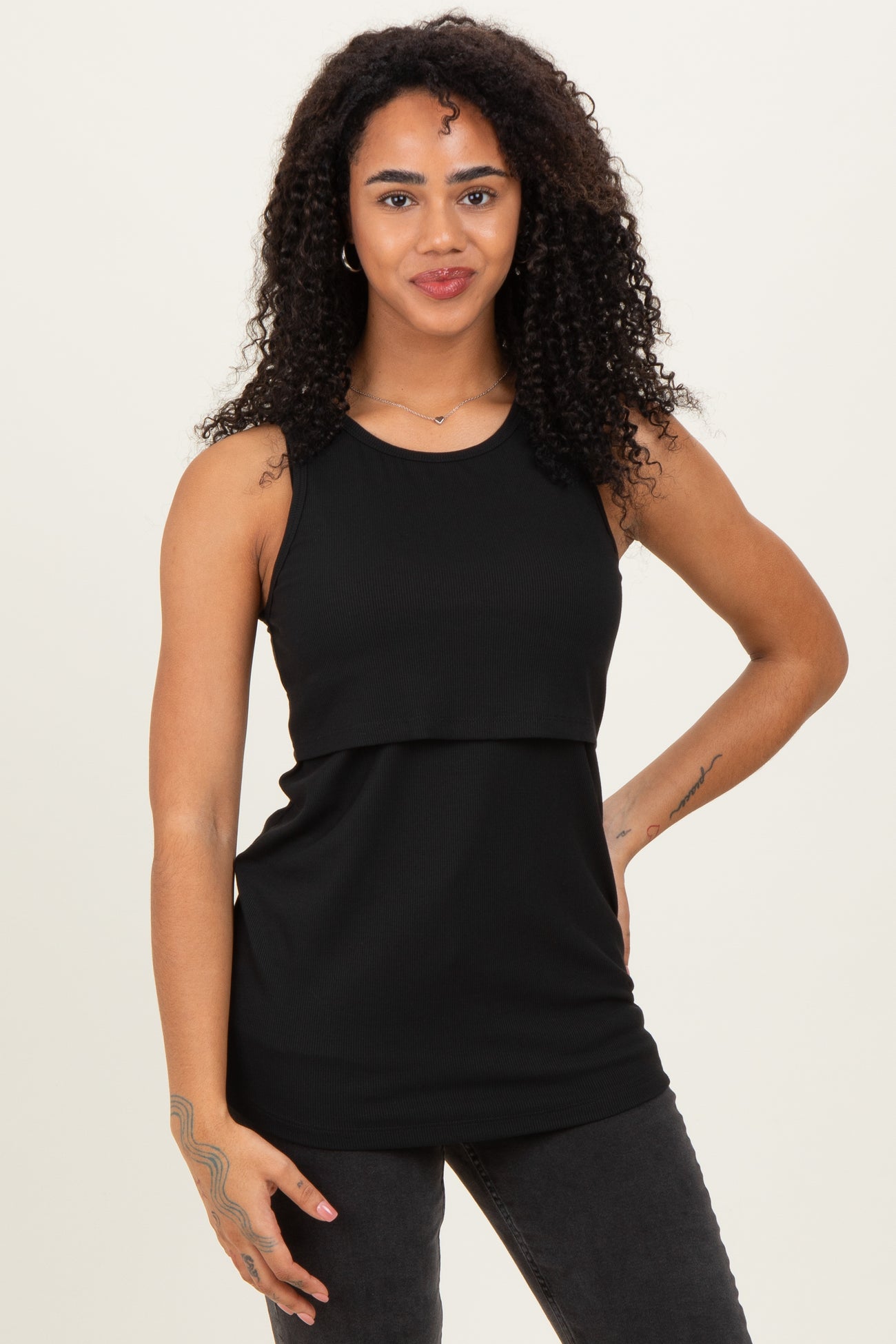 woman wearing a black sleeveless ribbed top with a layered design