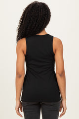 woman wearing a black ribbed tank top, viewed from the back against a neutral background