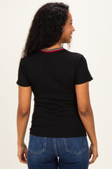 woman wearing a black short sleeve maternity top with colorful detailing on the neckline, viewed from the back