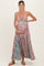 woman wearing a floral maternity maxi dress with a cutout detail and holding her baby bump