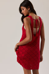 woman wearing a red crochet dress with a scooped back and tie detail, showcasing a relaxed fit