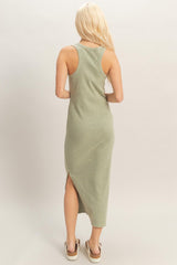 woman wearing a back view of an olive green sleeveless maxi dress with side slits and a fitted silhouette