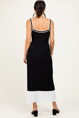 woman wearing a black and white striped ribbed maxi dress with a fitted silhouette and spaghetti straps