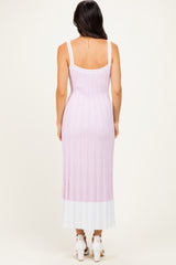 woman wearing a sleeveless pink and white ribbed maxi dress, seen from the back