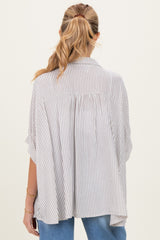 woman wearing a striped maternity tunic with a loose fit, showing the back and lightweight fabric