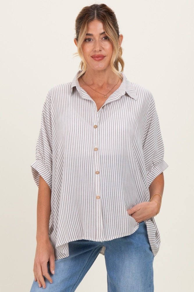 woman wearing a striped maternity blouse with a button front and relaxed fit, paired with blue jeans