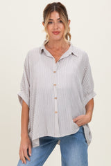 woman wearing a striped maternity blouse with a button front and relaxed fit, paired with blue jeans
