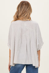 woman wearing a striped maternity top with loose fit and short sleeves, showing the back design