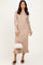 woman wearing a beige ribbed midi dress with ruffle hem and button details, holding a white handbag