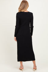 woman wearing a black ribbed maternity dress with long sleeves, shown from the back