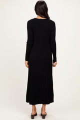 woman wearing a black ribbed long sleeve maxi dress, shown from the back