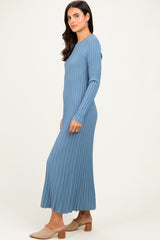 woman wearing a long sleeve light blue ribbed maxi dress with a fitted top and flowing skirt