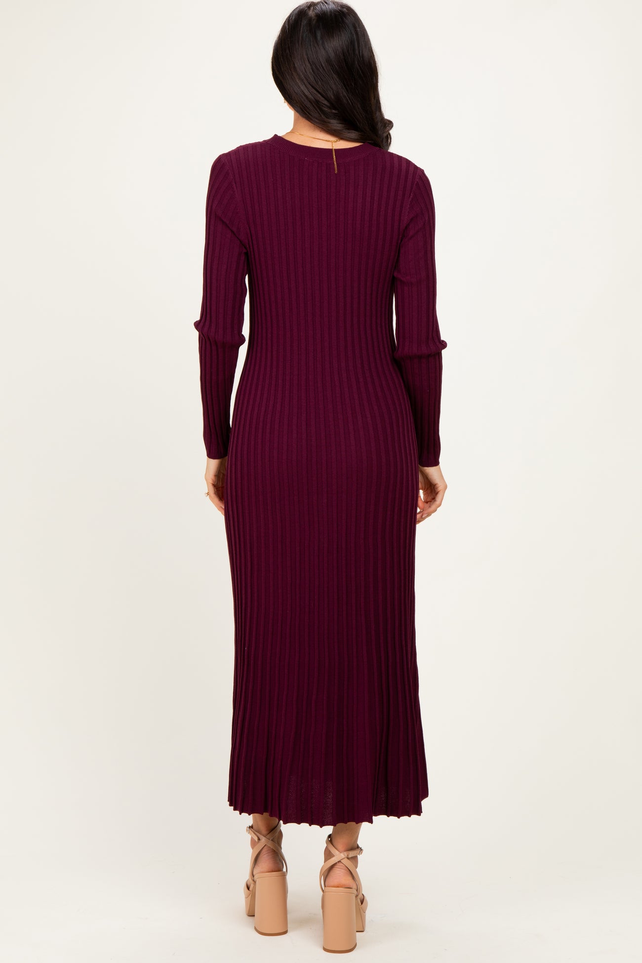 woman wearing a burgundy ribbed long sleeve maxi dress with a flared hem and back keyhole detail