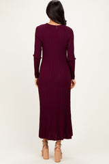 woman wearing a burgundy ribbed long sleeve maxi dress with a flared hem and back keyhole detail