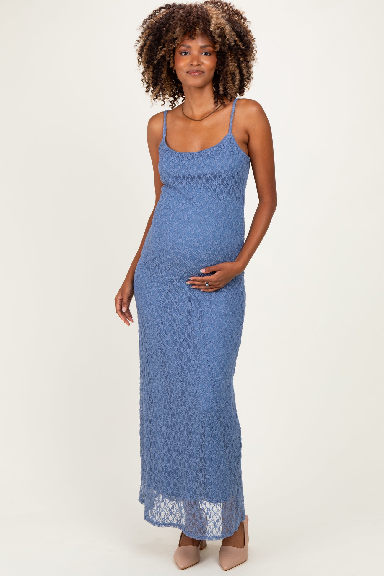 woman wearing a blue lace maternity maxi dress and holding her baby bump