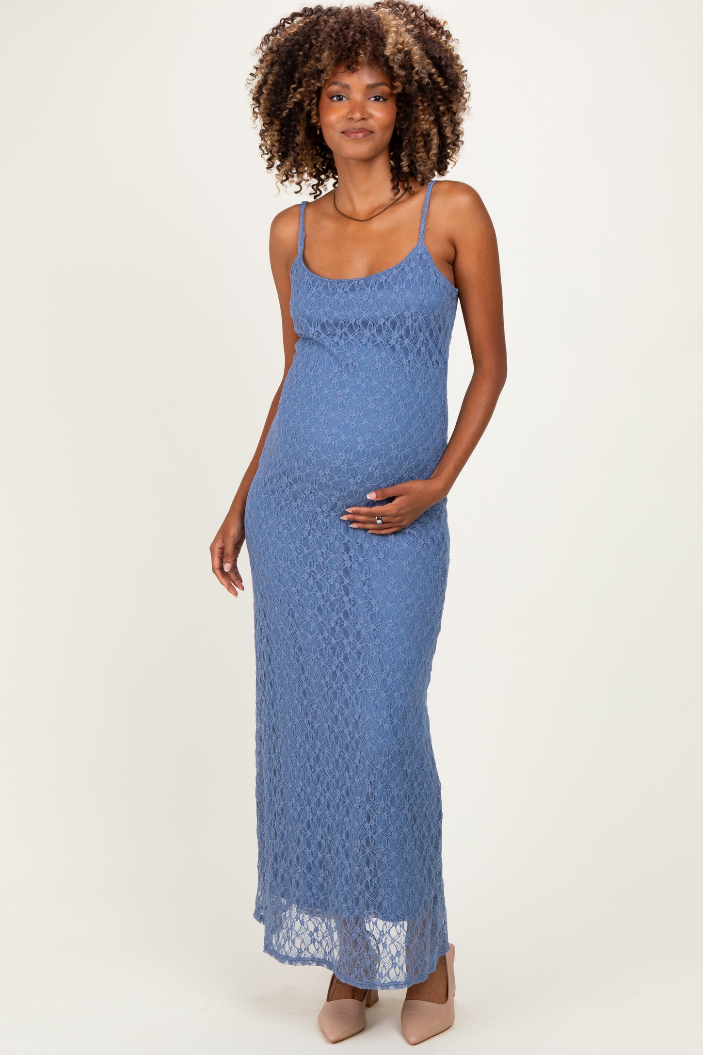woman wearing a blue lace maternity maxi dress and holding her baby bump