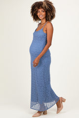 woman wearing a blue lace maternity maxi dress and showcasing her baby bump