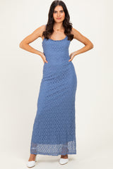 woman wearing a blue lace maxi dress with a fitted silhouette and spaghetti straps