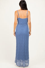 woman wearing a light blue lace maxi dress with thin straps and a fitted silhouette, viewed from the back